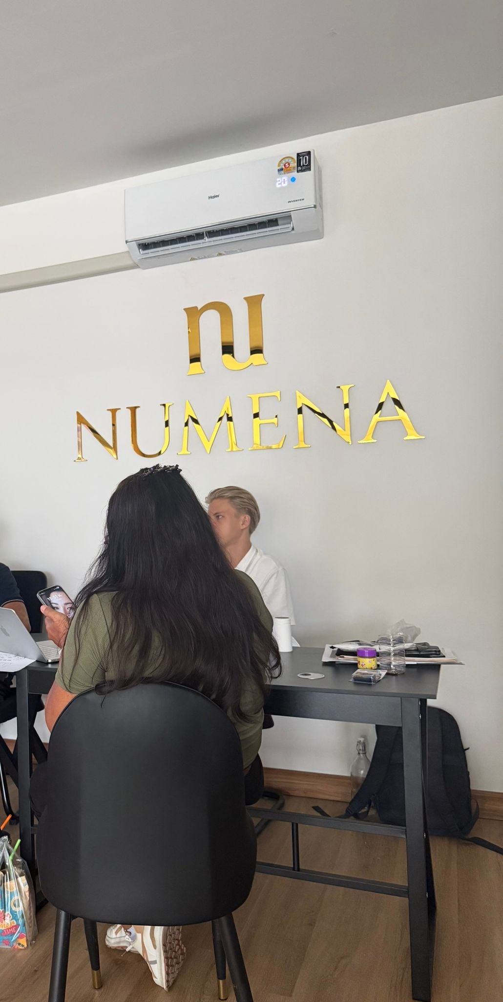 Inside the Numena office, the team at work under the gold Numena lettering